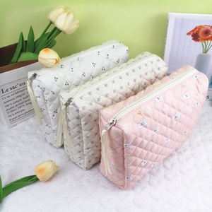 Quilted cotton makeup bags featuring cherry, floral, and rabbit patterns in soft pastel tones