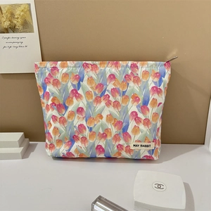 Detail of floral tulip makeup bag with MAY RABBIT label and smooth metal zipper
