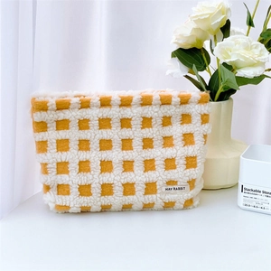Macro shot of yellow checkerboard waffle fabric texture with brand label on makeup bag