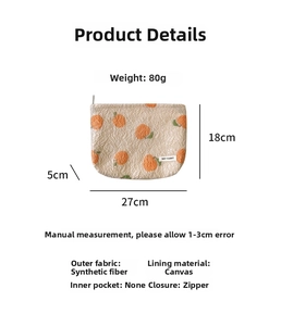 Detailed view of cream jacquard pouch with orange citrus pattern and zipper 27x18x5cm