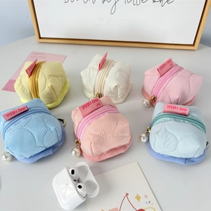 Quilted floral earphone pouches in macaron colors with metal hooks and pearl charms