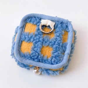 Detail of blue and yellow checkerboard plush earphone pouch with a metal ring and pearl charm