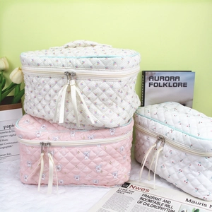Quilted makeup bags with cherry and rabbit prints featuring ribbon zip pulls and handles