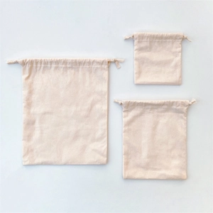 Three-piece set of natural cotton drawstring storage bags in different sizes