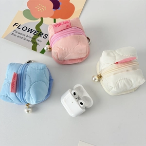 Quilted nylon earphone pouch in pink, blue, and white with pearl and carabiner charm