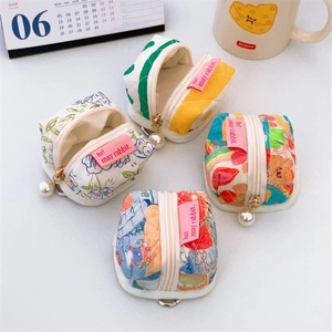 Cute tent-shaped mini storage pouches with floral patterns and pearl zipper details