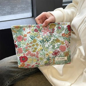Floral embroidered makeup pouch featuring vibrant botanical patterns and premium fabric detail