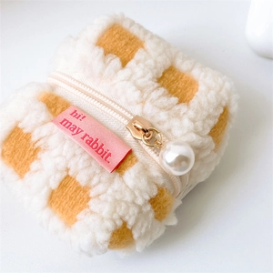 Detail of yellow checkerboard plush earphone case with pearl zipper charm