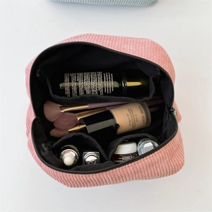 Top view showing the spacious interior and compartments of the pink corduroy makeup bag