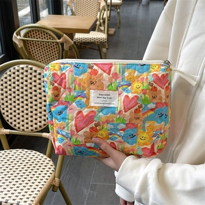 Detailed shot of quilted cotton makeup bag with cute cartoon sun and bear patterns