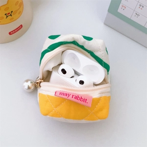 Detail of quilted mini tent earphone case with pearl pendant and brand label