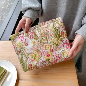 Detailed texture of floral jacquard embroidery on a large capacity makeup bag