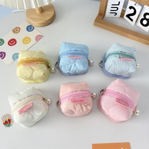 Macro shot of colorful quilted mini earphone pouches with elegant pearl zipper pulls