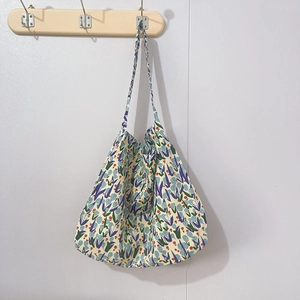 Close-up of vintage floral canvas tote bag featuring purple tulip prints on beige fabric