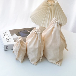 Three-piece set of drawstring cotton storage bags in small, medium and large sizes