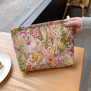 Embossed floral jacquard makeup bag with silver metal zipper and colorful embroidery