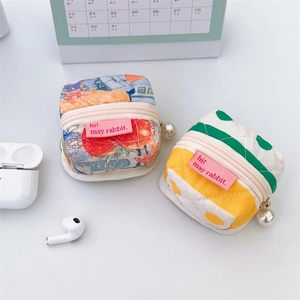 Quilted pouch with pearl pendant zipper showing illustration and polka dot patterns