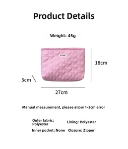 Quilted pink makeup bag detail showing 27x18x5cm dimensions and heart pattern fabric
