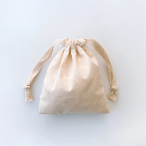 Detailed view of the natural texture and drawstring closure on a beige cotton canvas pouch