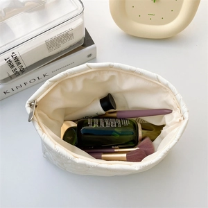 Quilted floral makeup bag showing large interior capacity for skincare and beauty brushes