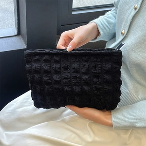 Detailed view of black bubble texture fabric on a large capacity makeup pouch