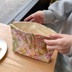 Detail of floral jacquard makeup bag showing premium texture and sturdy zipper closure
