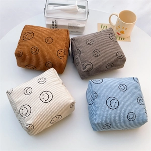 Group shot of four cute corduroy cosmetic bags with smiley faces in various colors