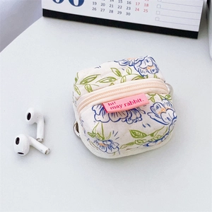 Detail of floral quilted cotton earphone case with pink zipper and metal hook
