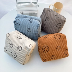 Cute smiley corduroy cosmetic bags set in beige, blue, grey, and ochre with zip closure