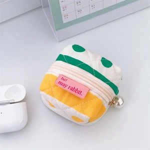 Quilted fabric headphone pouch with polka dots, zipper closure, and pearl charm detail