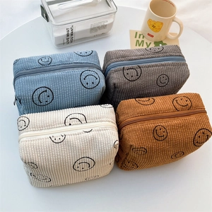 Large corduroy cosmetic bags with embroidered smiley faces in four assorted colors