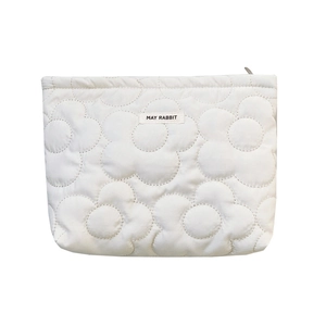 Quilted floral puffer cosmetic bag in cream white with a soft padded texture and zipper