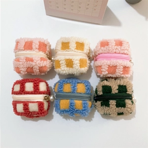 Flat lay of waffle plush earphone cases in six colors with pearl zipper charms