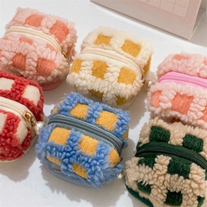 Macro shot of colorful waffle plush checkered mini bags with elegant pearl charms