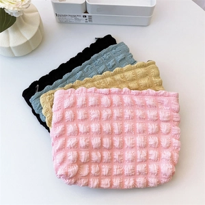 Detail of colorful bubble texture cosmetic bags featuring high-quality metal zippers