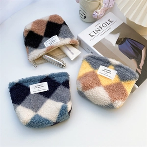 Plush quilted canvas makeup pouches in brown, blue, and yellow with zip closures