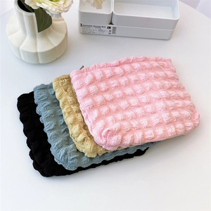 Detailed macro view of bubble textured fabric in four colors for cosmetic storage bag