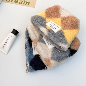 Detailed close-up of plush checkerboard cosmetic bags with metal ring zippers and fabric labels