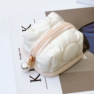 Detail of quilted floral earphone case with white texture and large pearl charm