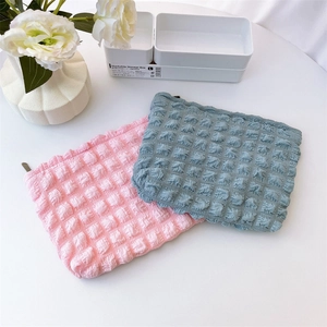 Detail of pink and blue popcorn texture cosmetic bags with soft quilted fabric