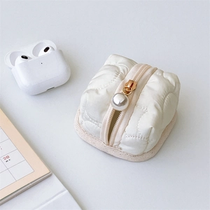 Quilted white mini earphone pouch with large pearl zipper detail and gold-tone hardware