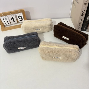 Detail showing the thick plush faux fur texture and branded label of the storage bag