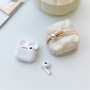 Detail of white quilted headphone case with premium pearl zipper and metal hardware