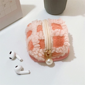 Detail of waffle fleece storage pouch with orange checkerboard pattern and pearl zipper pull