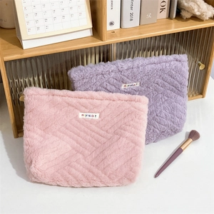 Cute fluffy plush organizer bags in pink and purple with wave texture and logo detail