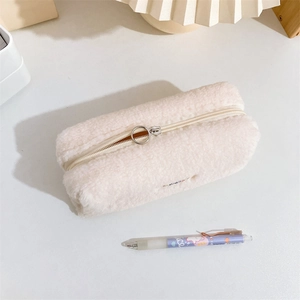 Detail of soft cream plush pencil case showing lamb wool texture and metal ring zipper