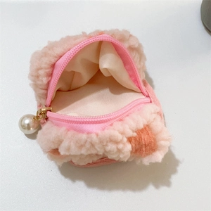 Close-up of pink sherpa waffle fleece storage pouch with an elegant pearl zipper detail