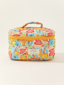 Close-up of quilted cotton makeup bag with colorful hand-drawn patterns and sturdy yellow zipper