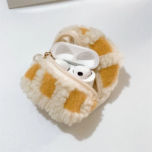Detail of yellow checkered plush earphone case with gold zipper and pearl charm