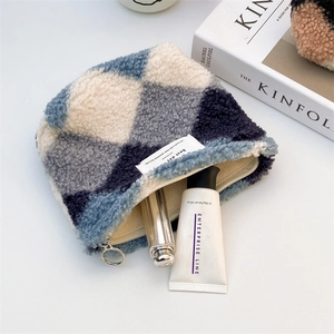 Detail of plush quilted organizer bag with silver zipper and cosmetic storage capacity
